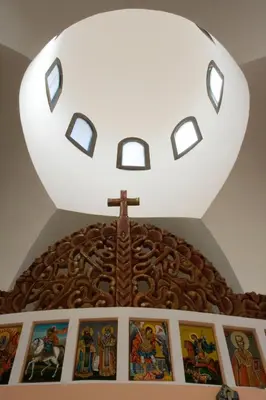 a cross on top of a church with pictures at Вила Бойковец in Boykovets