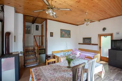 a dining room with a table and a ceiling fan at Вила Бойковец in Boykovets