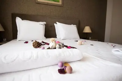 a group of stuffed animals sitting on top of a bed at Court Inn in Panagyurishte