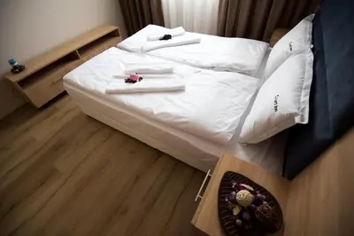 a bedroom with two white beds with towels on them at Court Inn in Panagyurishte