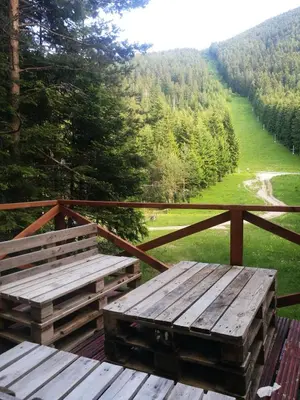 a table and benches on a balcony with a view at Art Studio in Sapareva Banya