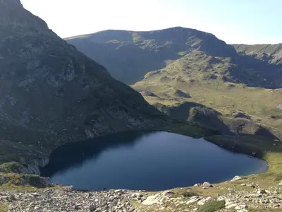 a large blue lake in the middle of a mountain at Art Studio in Sapareva Banya
