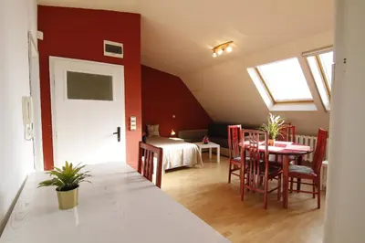 a room with a table and chairs and a bedroom at Guest Rooms Stay Nexus in Sofia