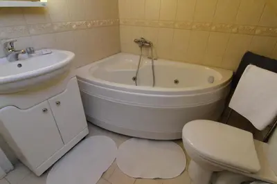 a bathroom with a tub and a toilet and a sink at Guest Rooms Stay Nexus in Sofia