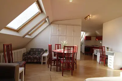 a living room with a table and red chairs at Guest Rooms Stay Nexus in Sofia