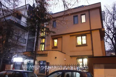 a building with cars parked in front of it at Guest Rooms Stay Nexus in Sofia