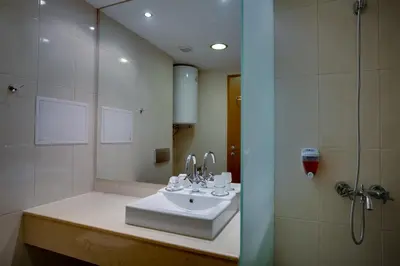 a bathroom with a sink and a shower at Effect Malina Residence Hotel in Pamporovo
