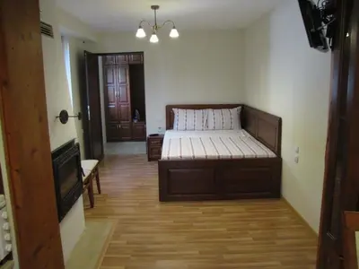 a bedroom with a bed in the middle of a room at Guest House Vergie, Fully Private in Sapareva Banya