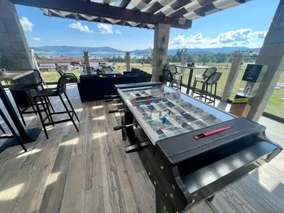 a ping pong table on a deck with a view at Family Hotel Eterno in Tsigov Chark