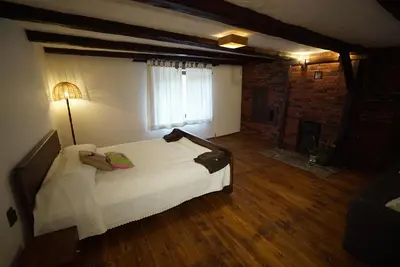 a bedroom with a large white bed and a window at Pisanata House in Dedovo
