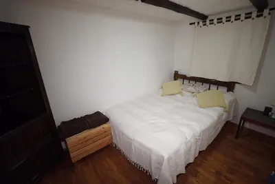 a bedroom with a white bed with two yellow pillows at Pisanata House in Dedovo