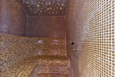 a large tiled bathroom with a tub in a room at Belvedere Holiday Club in Bansko