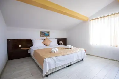 a bedroom with a bed and a large window at Guest House Holiday in Ognyanovo
