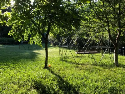 a park with a swing set in the grass at Бунгала Дара in Kalofer