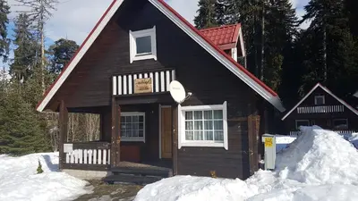 a small house with snow in front of it at Chalet Taffski in Borovets