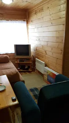 a living room with a couch and a television at Chalet Taffski in Borovets