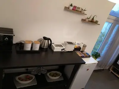 a kitchen with a counter with bowls of fruit on it at Graf Ignatiev - 3BR APART in Sofia