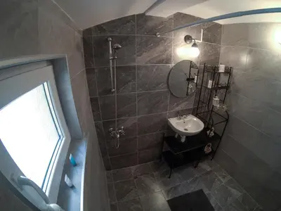 a bathroom with a sink and a shower with a mirror at Graf Ignatiev - 3BR APART in Sofia