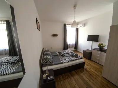 a small bedroom with a bed and a mirror at Graf Ignatiev - 3BR APART in Sofia