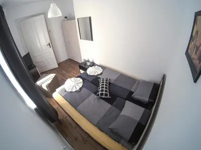 a bedroom with a large black bed in a room at Graf Ignatiev - 3BR APART in Sofia