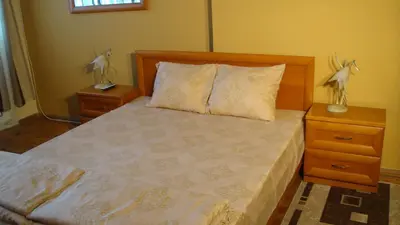 a bedroom with a bed with two night stands and two lamps at Apartment SOFIA Center in Sofia