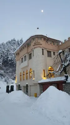 a building with a pile of snow in front of it at The Castle Hotel in Samokov