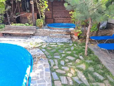 a pool with two blue trays in a yard at Keremidchieva Kushta Guest House in Sandanski