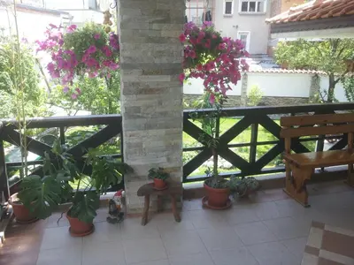 a balcony with potted plants and a wooden fence at Keremidchieva Kushta Guest House in Sandanski