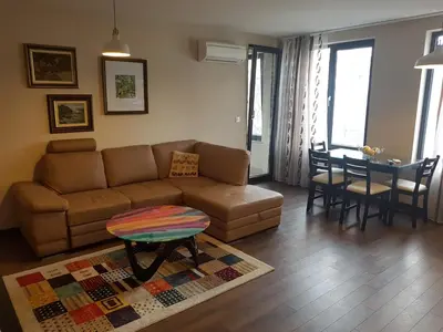 a living room with a couch and a table at Apartments Sofia Yavorov in Sofia