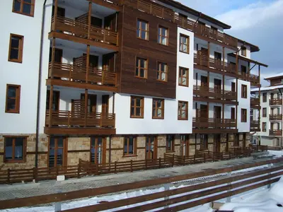 a building with wooden balconies on the side of it at Mountain View Resort Studio in Bansko