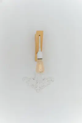 a light fixture on a white wall with at Mouse House Kapana in Plovdiv