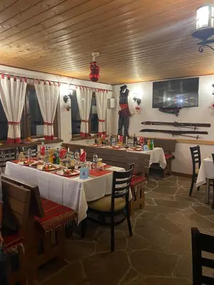 a dining room with a table with food on it at Nevada Aparthotel in Pamporovo