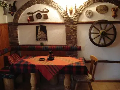 a room with a table and aokedokedoked at Mavrikova Kushta in Bansko