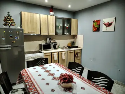 a small kitchen with a table and a refrigerator at Apartment Diana in Resilovo