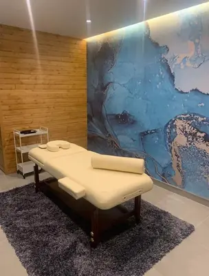 a massage table in a room with a painting on the wall at Apartment in Borovets Gardens C17 in Borovets