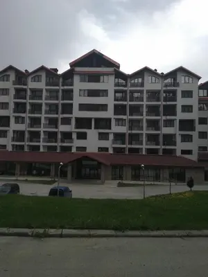 a large apartment building with a parking lot at Apartment in Borovets Gardens C17 in Borovets