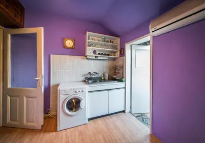 a purple kitchen with a washing machine and a sink at Sunny Apartment Sofia in Sofia