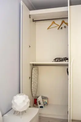 a walk in closet with a white door and shelves at Vacation Apartment in Plovdiv
