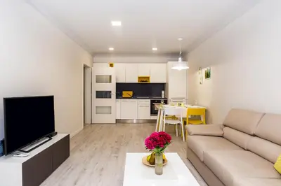 a living room with a couch and a tv at Vacation Apartment in Plovdiv