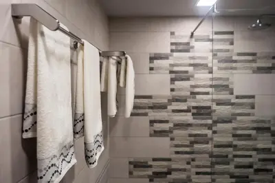 a bathroom with white towels and a shower at Vacation Apartment in Plovdiv