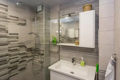 a bathroom with a sink and a shower at Vacation Apartment in Plovdiv