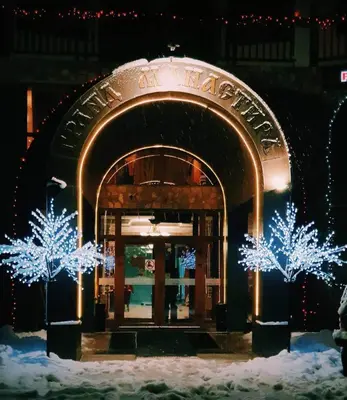 a building with christmas lights in front of it at Grand Monastery Private Apartments in Pamporovo