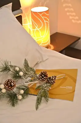 a christmas decoration on a bed with a lamp at Grand Monastery Private Apartments in Pamporovo