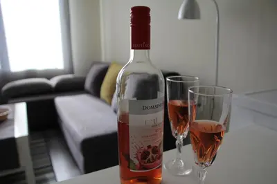 a bottle of wine next to two glasses on a table at Apartment 46 in Sofia