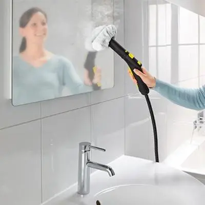 a woman holding a brush in front of a mirror at Apartment 46 in Sofia