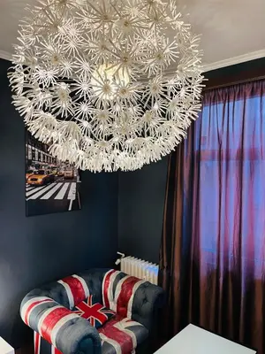 a large chandelier in a living room with a couch at Lovely place in Sofia