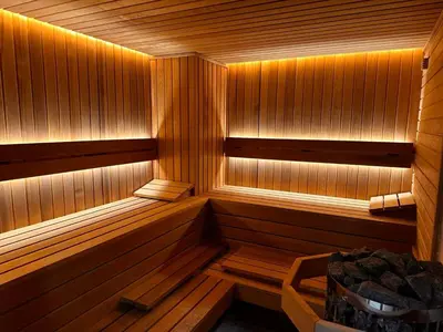 an empty sauna with wooden paneled walls and wooden floors at Park Hotel Ela in Borovets