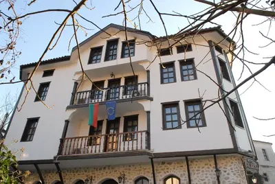 a large white building with a balcony at Hotel Bolyarka in Melnik