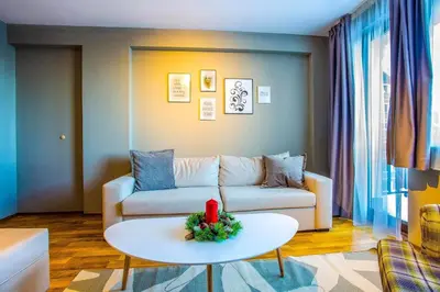 a living room with a couch and a table at Sunny Hills Ski&Wellness in Pamporovo