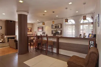 a kitchen and living room with a bar and chairs at Anita House in Perushtitsa